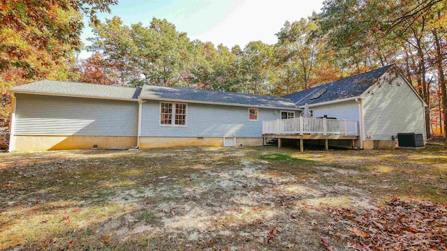 rear view of property with a wooden deck and central AC unit