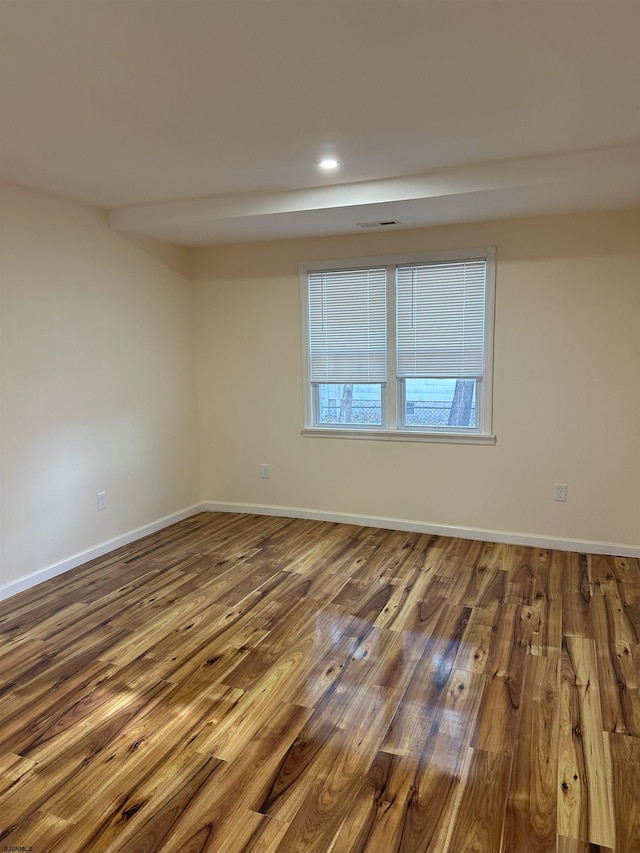 unfurnished room with hardwood / wood-style flooring