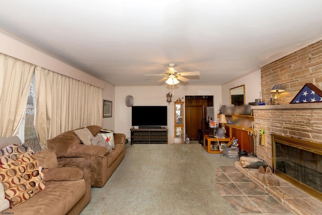 living room with ceiling fan, crown molding, carpet floors, and a fireplace