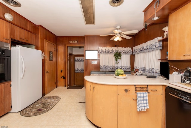 kitchen with wooden walls, black appliances, and ceiling fan