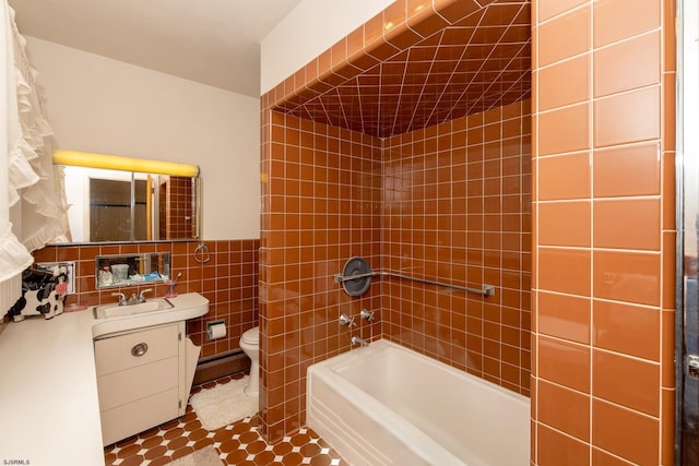 full bathroom with vanity, toilet, tile walls, and shower / tub combo with curtain