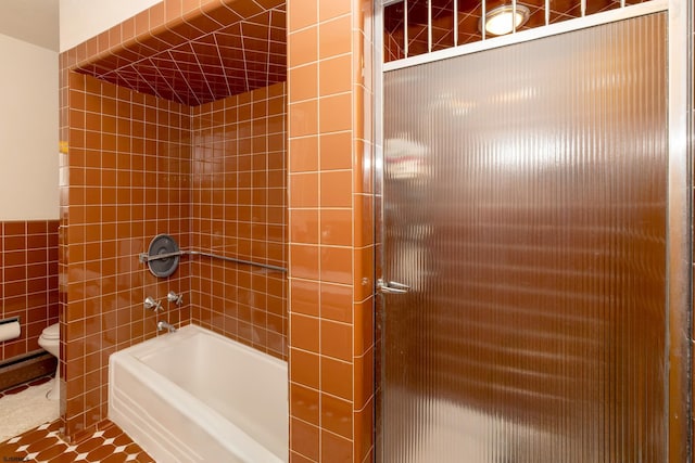 bathroom featuring toilet, tile walls, separate shower and tub, and tile patterned flooring