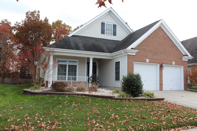 front facade featuring a porch, a front yard, and a garage