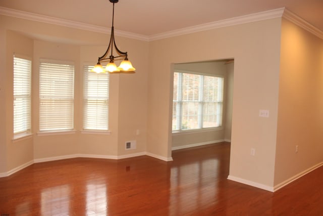 spare room with crown molding and dark hardwood / wood-style flooring