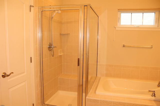 bathroom featuring independent shower and bath