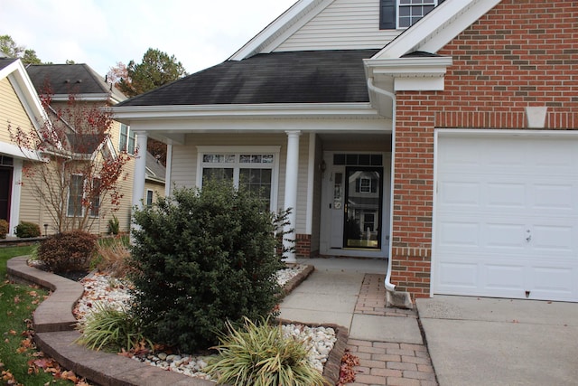 16 Primrose Cir, Egg Harbor, NJ 08234 - view of exterior entry with brick siding, a garage, and covered porch