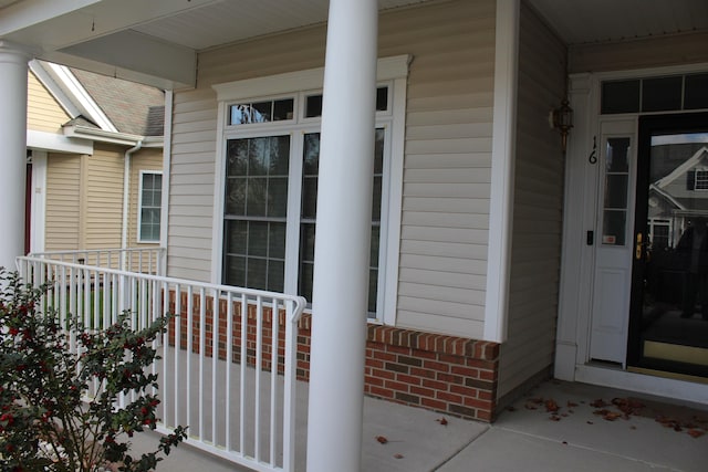 view of exterior entry with a porch