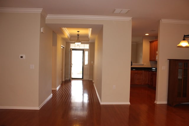 hall featuring ornamental molding and dark hardwood / wood-style floors