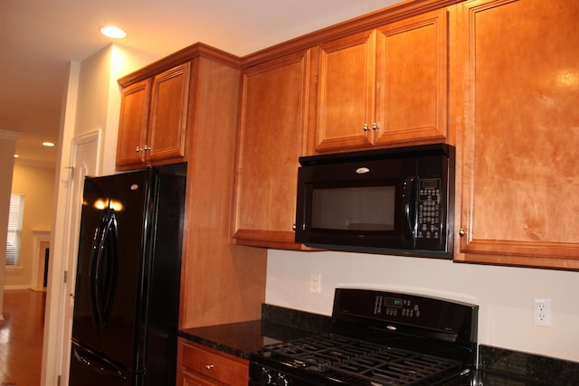 16 Primrose Cir, Egg Harbor, NJ 08234 - kitchen with black appliances, brown cabinets, dark stone countertops, wood finished floors, and recessed lighting