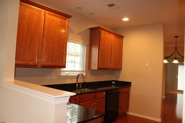 kitchen featuring black dishwasher, ornamental molding, dark hardwood / wood-style floors, pendant lighting, and sink