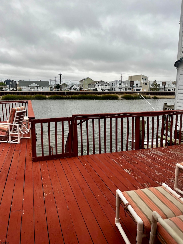 wooden terrace featuring a water view