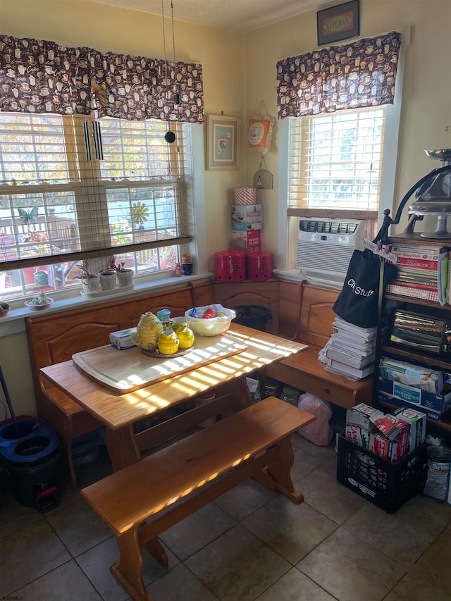 dining area featuring tile patterned flooring and cooling unit