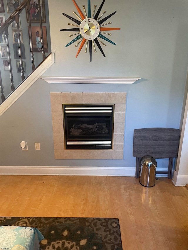 room details with hardwood / wood-style flooring and a fireplace