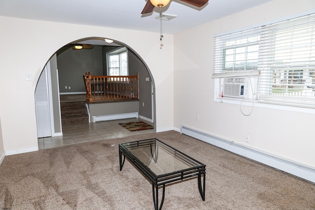 carpeted living room with ceiling fan, a baseboard radiator, and cooling unit