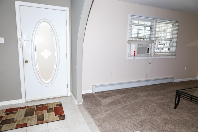 foyer with cooling unit, light tile patterned flooring, and a baseboard heating unit