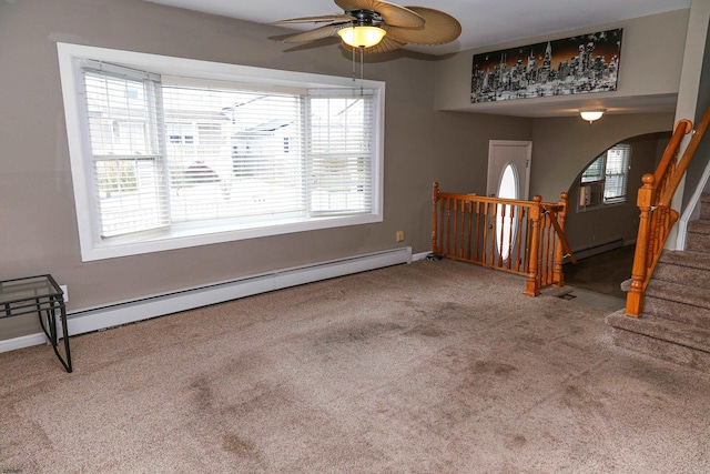 foyer entrance with ceiling fan, a healthy amount of sunlight, carpet flooring, and a baseboard radiator