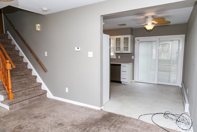 kitchen with light carpet, ceiling fan, baseboard heating, stainless steel dishwasher, and white cabinets