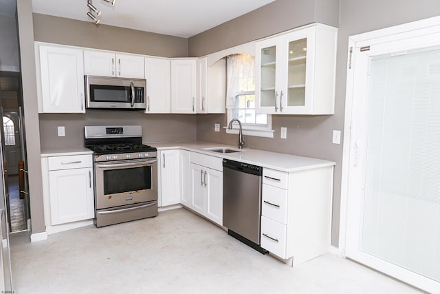 kitchen with white cabinets, stainless steel appliances, and sink