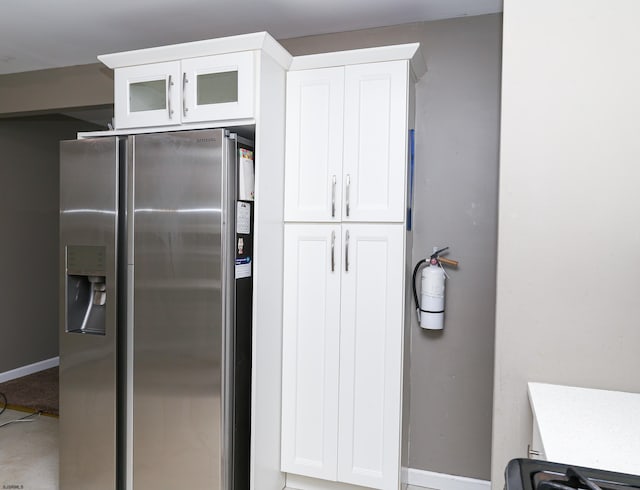 kitchen with white cabinets and stainless steel refrigerator with ice dispenser