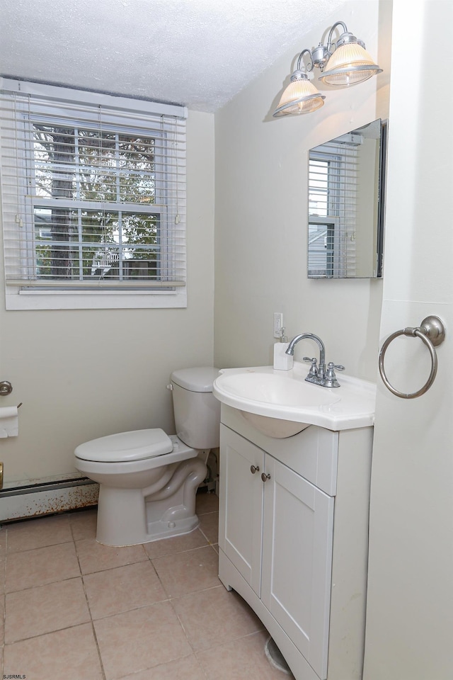 bathroom featuring tile patterned flooring, vanity, a textured ceiling, and toilet