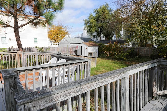 wooden terrace with a storage shed