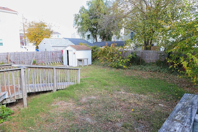 view of yard with a storage unit and a deck