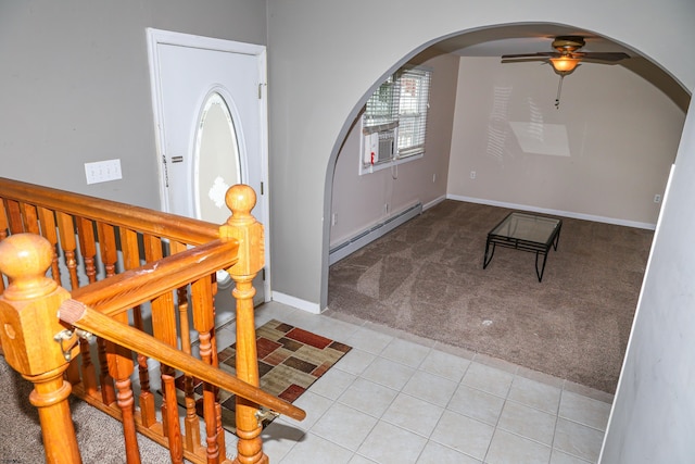 carpeted entrance foyer featuring baseboard heating and ceiling fan