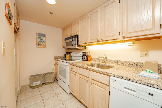 kitchen with light stone counters, sink, light tile patterned flooring, light brown cabinets, and white appliances