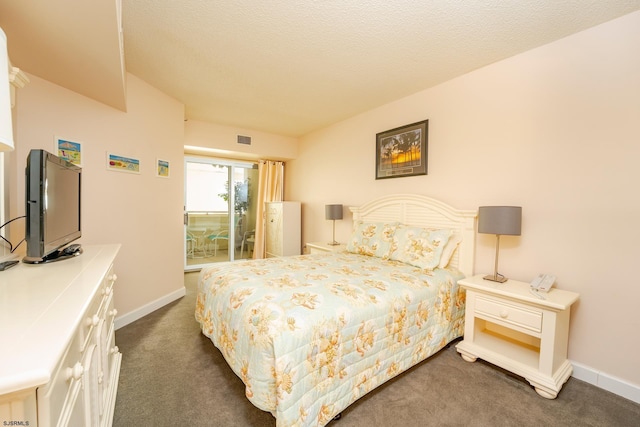 carpeted bedroom featuring a textured ceiling