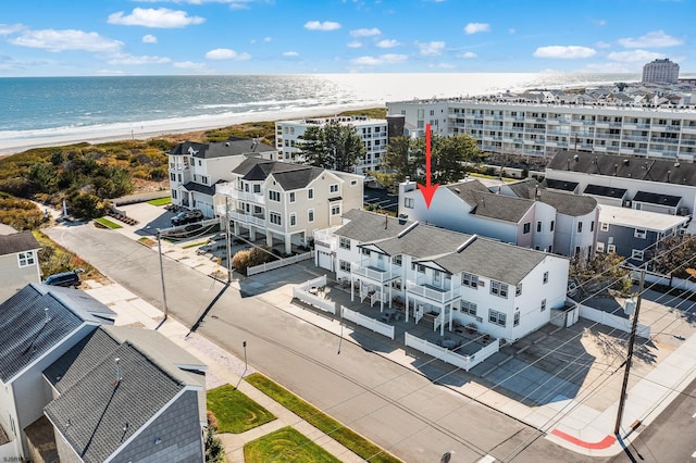 drone / aerial view featuring a view of the beach and a water view