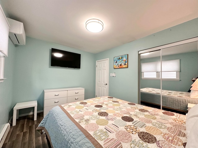 bedroom featuring a closet, a wall mounted air conditioner, baseboard heating, and dark hardwood / wood-style floors