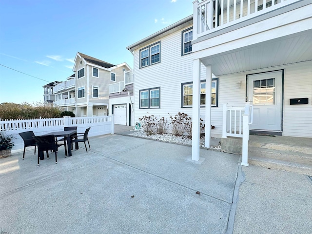 view of patio with a balcony and a garage