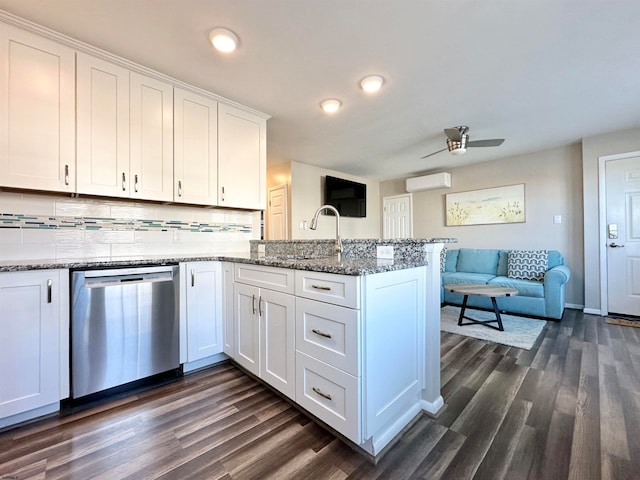 kitchen with dishwasher, white cabinetry, dark wood-type flooring, and a wall unit AC