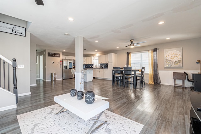 living room with ceiling fan, dark hardwood / wood-style floors, and sink