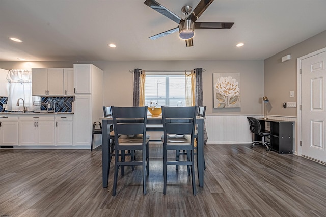 dining space with dark hardwood / wood-style floors, sink, and ceiling fan