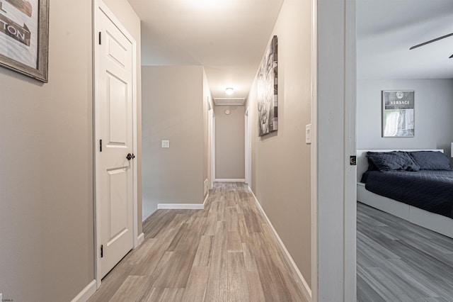 hallway with light hardwood / wood-style floors