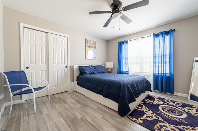 bedroom featuring hardwood / wood-style flooring, ceiling fan, and a closet