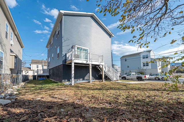 back of house featuring a yard and a wooden deck