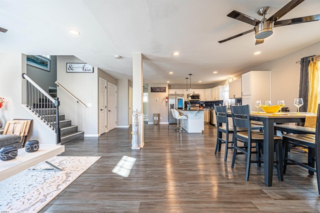 dining room with dark wood-type flooring and ceiling fan