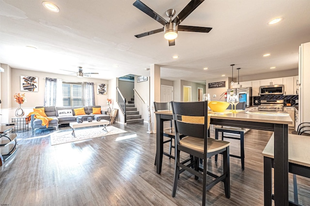 dining area featuring dark wood-type flooring and ceiling fan