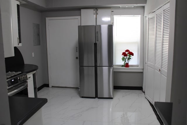 1828 Reverend J J Walters Ave, Atlantic City, NJ 08401 - kitchen featuring freestanding refrigerator, gas range oven, dark countertops, light marble finish floors, and electric panel