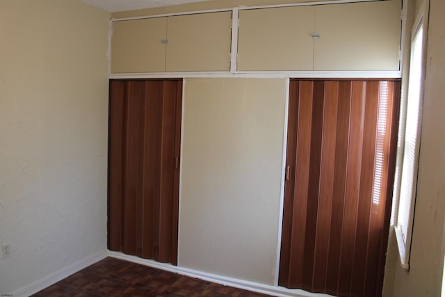 unfurnished bedroom featuring dark parquet floors