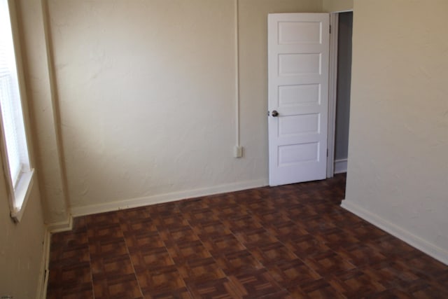 empty room featuring dark parquet floors