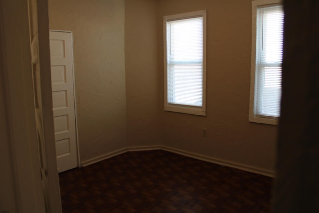 empty room featuring dark parquet flooring