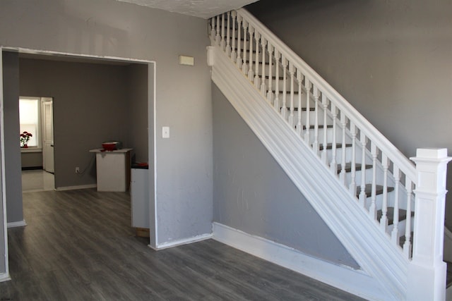 stairway featuring wood-type flooring