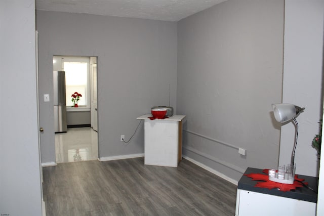 miscellaneous room with dark hardwood / wood-style flooring and a textured ceiling