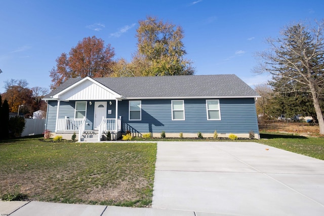 single story home with a porch and a front yard