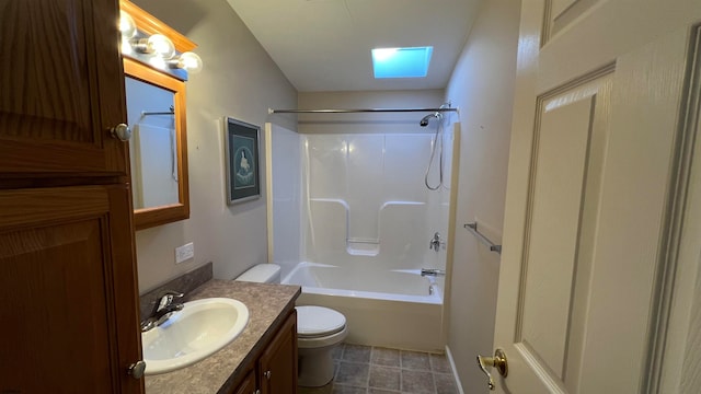 full bathroom featuring toilet, vanity, a skylight, and bathing tub / shower combination