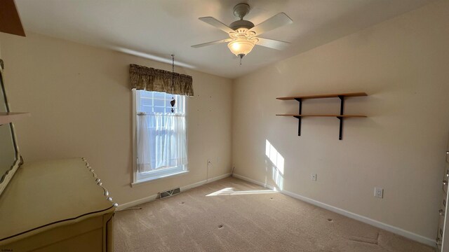 empty room with carpet flooring and ceiling fan