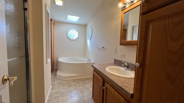 bathroom featuring separate shower and tub, vanity, and a skylight